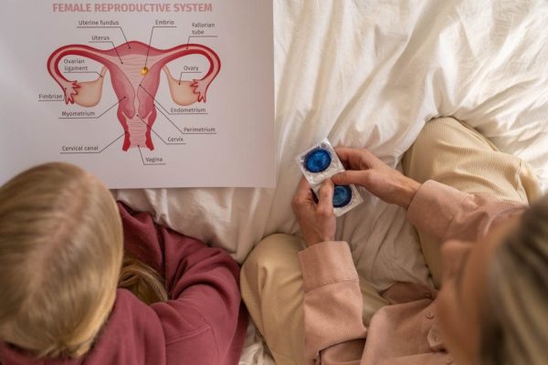 A mother and daughter learning about female reproductive health and contraception.